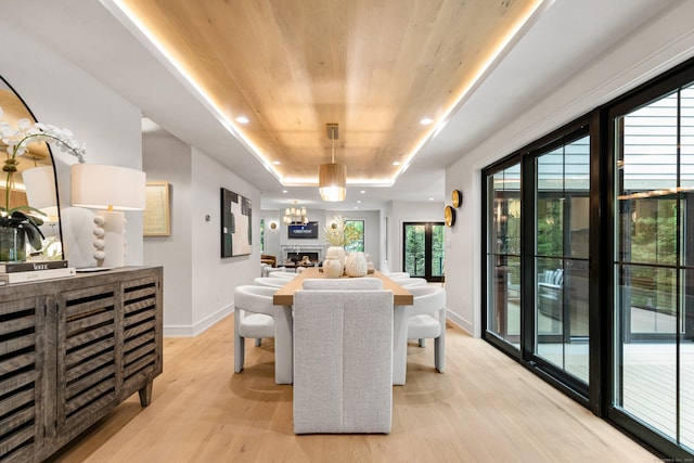 26 Hitchcock Rd, Westport, CT 06880 - dining space with light wood-style flooring, baseboards, a tray ceiling, a fireplace, and wooden ceiling