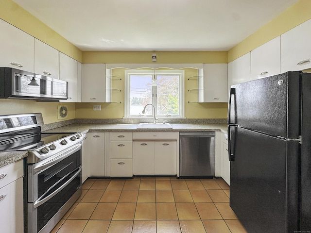 870 Lakeside Dr, Bridgeport, CT 06606 - kitchen with a sink, light tile patterned flooring, white cabinets, and appliances with stainless steel finishes