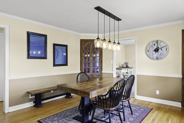 870 Lakeside Dr, Bridgeport, CT 06606 - dining area with baseboards, crown molding, and wood finished floors