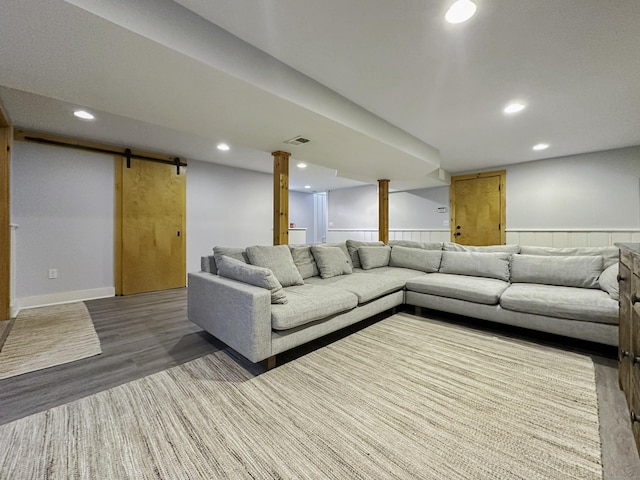 870 Lakeside Dr, Bridgeport, CT 06606 - living area with a wainscoted wall, wood finished floors, a barn door, visible vents, and recessed lighting