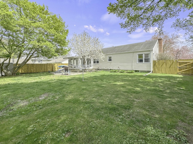 870 Lakeside Dr, Bridgeport, CT 06606 - back of house featuring a yard, fence, and a chimney