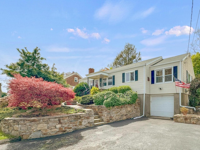 870 Lakeside Dr, Bridgeport, CT 06606 - ranch-style house featuring aphalt driveway, an attached garage, and a chimney