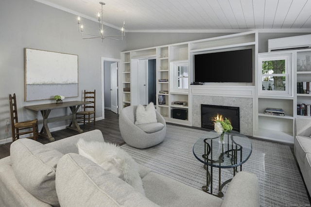 living room with an AC wall unit, lofted ceiling, a chandelier, wood finished floors, and a warm lit fireplace