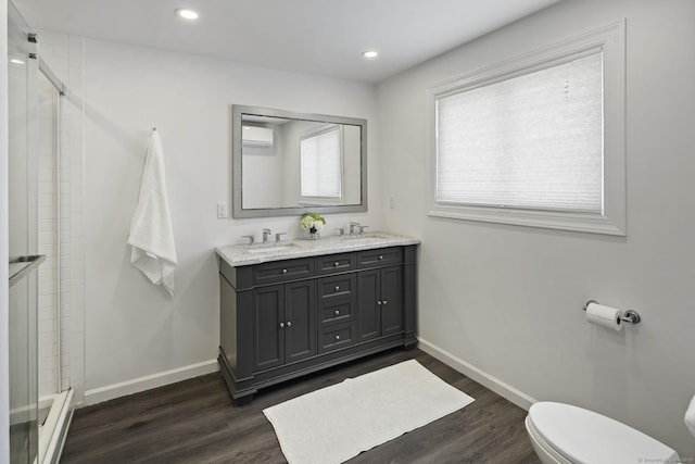 bathroom with toilet, a shower stall, wood finished floors, a wall mounted AC, and recessed lighting