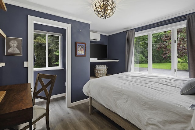 bedroom featuring a wall mounted air conditioner, wood finished floors, ornamental molding, baseboards, and a chandelier