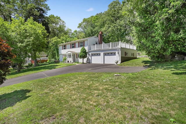 37 Shawnee Rd, Trumbull, CT 06611 - view of front of home featuring asphalt driveway, a chimney, and a front yard
