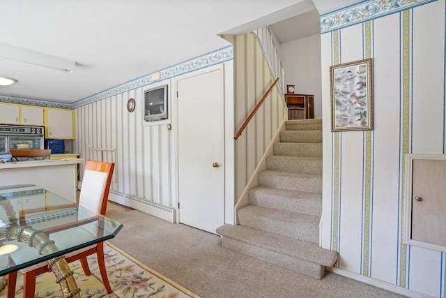 37 Shawnee Rd, Trumbull, CT 06611 - stairs featuring wallpapered walls, carpet flooring, and a baseboard radiator