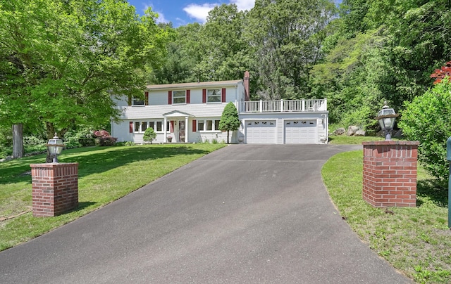 37 Shawnee Rd, Trumbull, CT 06611 - colonial house with driveway, a front lawn, a balcony, an attached garage, and a chimney