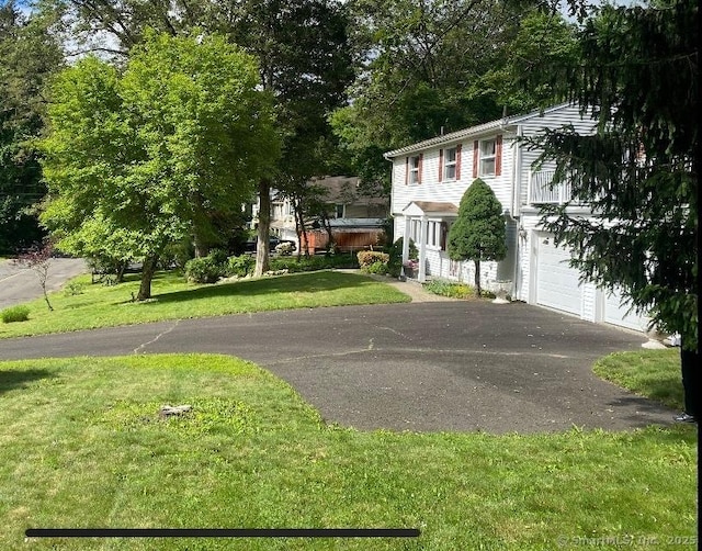 37 Shawnee Rd, Trumbull, CT 06611 - view of front of home featuring driveway, an attached garage, and a front yard