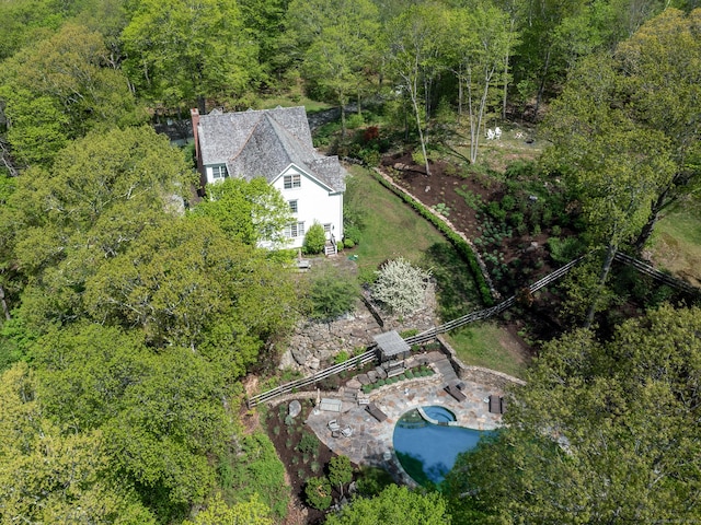 view of subject property featuring a forest