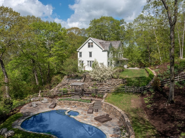 view of swimming pool with a patio area, fence, and a pool with connected hot tub