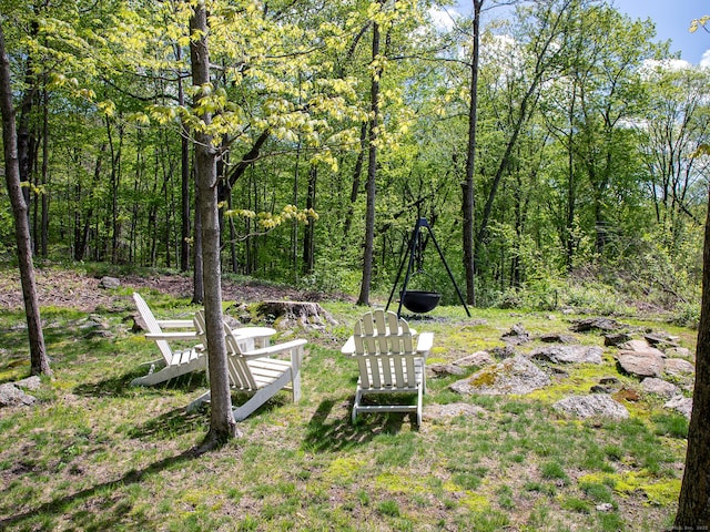view of yard featuring a forest view