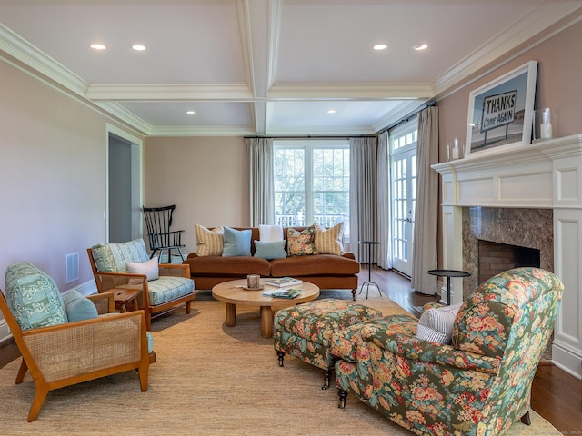 living room featuring ornamental molding, beam ceiling, recessed lighting, coffered ceiling, and a premium fireplace