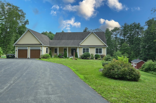 5 Kies Rd, Killingly, CT 06239 - view of front of house featuring an attached garage, a front lawn, driveway, and roof with shingles
