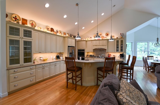 5 Kies Rd, Killingly, CT 06239 - kitchen with high vaulted ceiling, appliances with stainless steel finishes, a breakfast bar area, light wood-style flooring, and recessed lighting