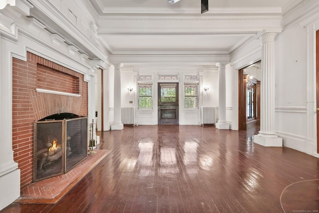 unfurnished living room featuring radiator heating unit, a fireplace, and decorative columns