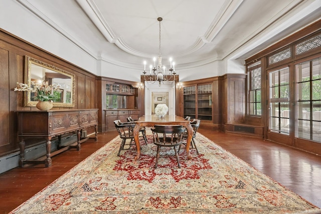 dining space featuring an inviting chandelier, crown molding, a wealth of natural light, and dark wood-style flooring