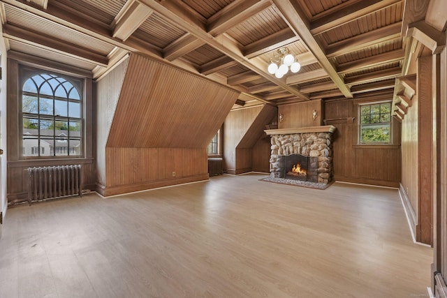 unfurnished living room with radiator, wood ceiling, wood finished floors, and beam ceiling