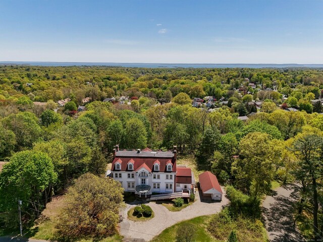 drone / aerial view with a wooded view