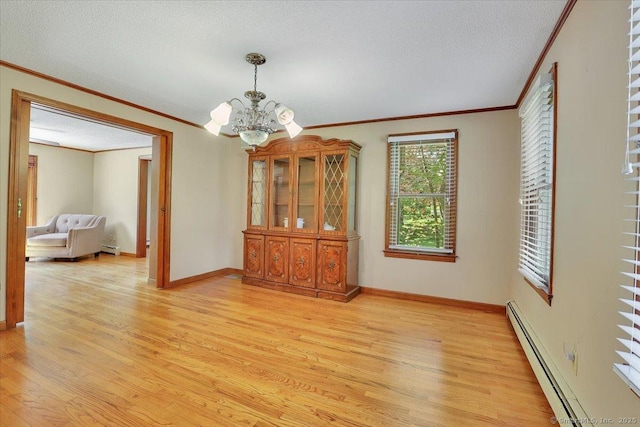 32 Powder Hill Rd, Middlefield, CT 06455 - dining room with baseboard heating, ornamental molding, light wood-style floors, a chandelier, and baseboards