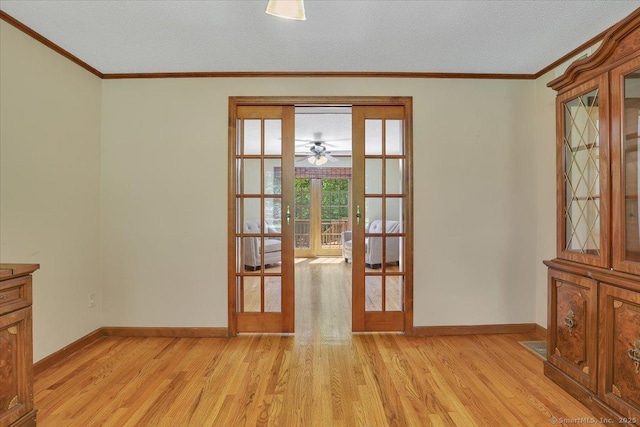 32 Powder Hill Rd, Middlefield, CT 06455 - spare room featuring french doors, light wood-style floors, baseboards, crown molding, and a textured ceiling