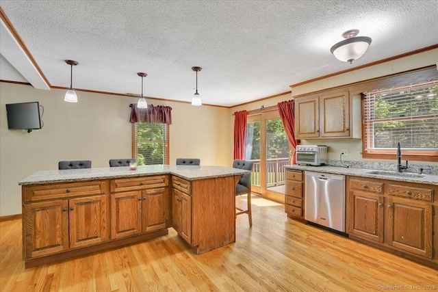 32 Powder Hill Rd, Middlefield, CT 06455 - kitchen with a sink, stainless steel dishwasher, a textured ceiling, light wood-type flooring, and pendant lighting