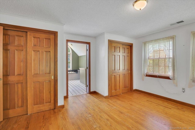 32 Powder Hill Rd, Middlefield, CT 06455 - entryway with light wood finished floors, a textured ceiling, and baseboards