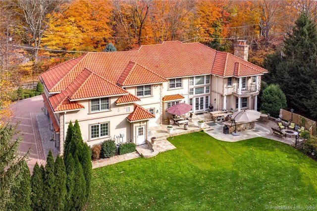 79 Comstock Hill Ave, Norwalk, CT 06850 - back of house with a balcony, a patio area, a chimney, and a tile roof