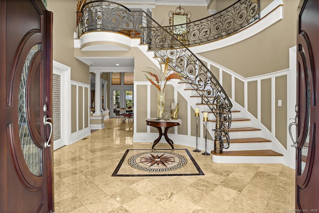 79 Comstock Hill Ave, Norwalk, CT 06850 - foyer entrance featuring a high ceiling, ornate columns, stairs, ornamental molding, and baseboards