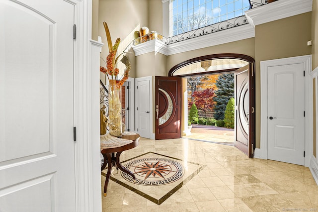 79 Comstock Hill Ave, Norwalk, CT 06850 - entryway with inlaid floor details, a towering ceiling, light marble finish flooring, and baseboards