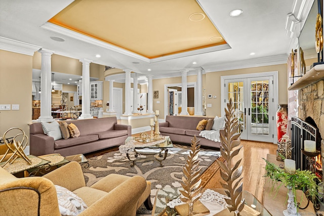 79 Comstock Hill Ave, Norwalk, CT 06850 - living area with decorative columns, a tray ceiling, recessed lighting, crown molding, and light wood finished floors