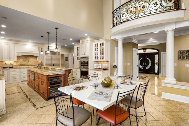 79 Comstock Hill Ave, Norwalk, CT 06850 - dining area featuring ornate columns, light tile patterned floors, recessed lighting, baseboards, and crown molding