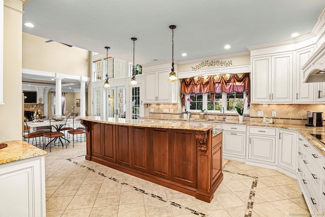 79 Comstock Hill Ave, Norwalk, CT 06850 - kitchen with ornate columns, white cabinets, light stone countertops, recessed lighting, and ornamental molding