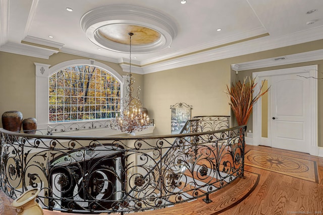 79 Comstock Hill Ave, Norwalk, CT 06850 - corridor with a raised ceiling, a chandelier, wood finished floors, crown molding, and an upstairs landing
