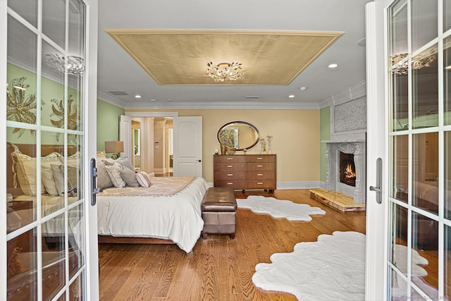 79 Comstock Hill Ave, Norwalk, CT 06850 - bedroom with wood finished floors, a fireplace, ornamental molding, recessed lighting, and baseboards