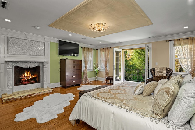 79 Comstock Hill Ave, Norwalk, CT 06850 - bedroom with access to exterior, wood finished floors, crown molding, a fireplace, and recessed lighting