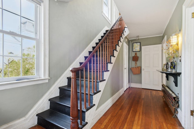 staircase with baseboards and wood-type flooring
