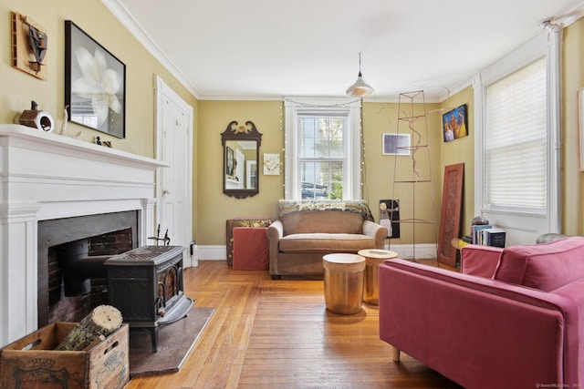 living area with crown molding, a wood stove, parquet flooring, and baseboards