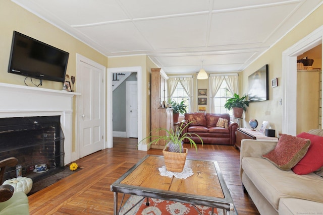 living room featuring baseboards and a fireplace with flush hearth