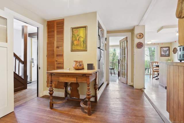 hallway with stairs and hardwood / wood-style floors