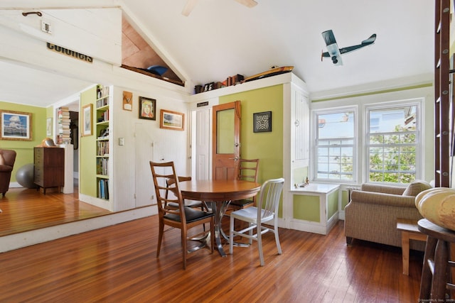 dining room with a ceiling fan, lofted ceiling with beams, wood-type flooring, and baseboards