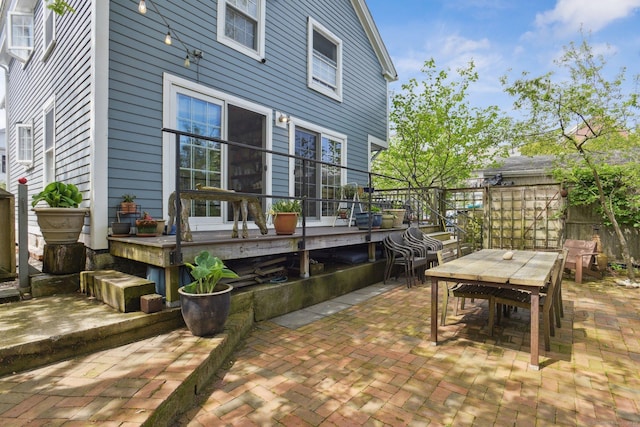 view of patio / terrace featuring outdoor dining area and a wooden deck