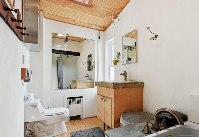 bathroom featuring lofted ceiling, toilet, radiator, wood finished floors, and wooden ceiling