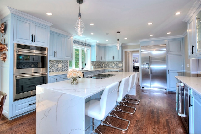 11 Tall Pines Dr, Weston, CT 06833 - kitchen featuring stainless steel appliances, ornamental molding, a kitchen island, dark wood finished floors, and backsplash