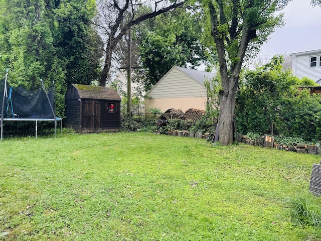 158 Louisiana Ave, Bridgeport, CT 06610 - view of grassy yard featuring a shed, a trampoline, and an outdoor structure