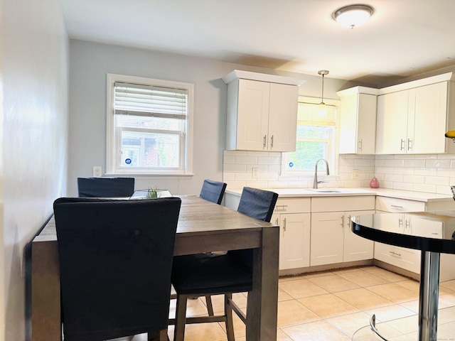 158 Louisiana Ave, Bridgeport, CT 06610 - kitchen with a sink, tasteful backsplash, light countertops, and light tile patterned flooring