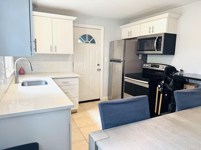 158 Louisiana Ave, Bridgeport, CT 06610 - kitchen featuring stainless steel appliances, a sink, tasteful backsplash, light countertops, and white cabinets
