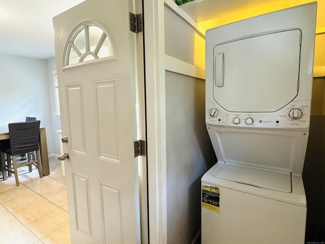 158 Louisiana Ave, Bridgeport, CT 06610 - laundry room featuring stacked washing machine and dryer and light tile patterned floors