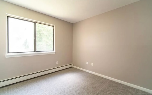 carpeted empty room with baseboards and a baseboard radiator