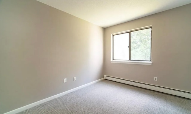 carpeted spare room with baseboards and baseboard heating